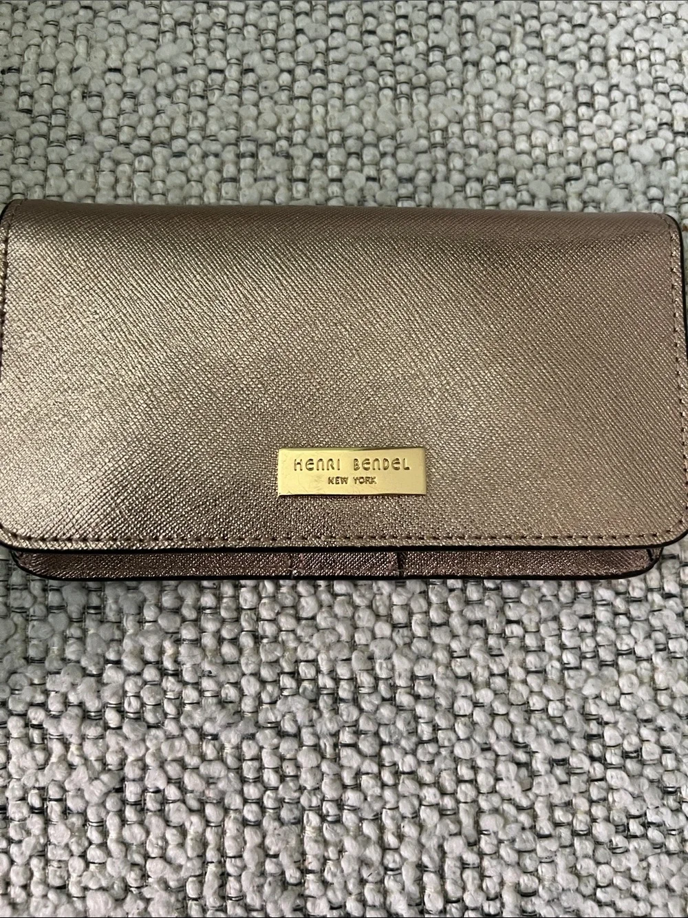 henri bendel metallic rose gold wallet with gold-tone plaque